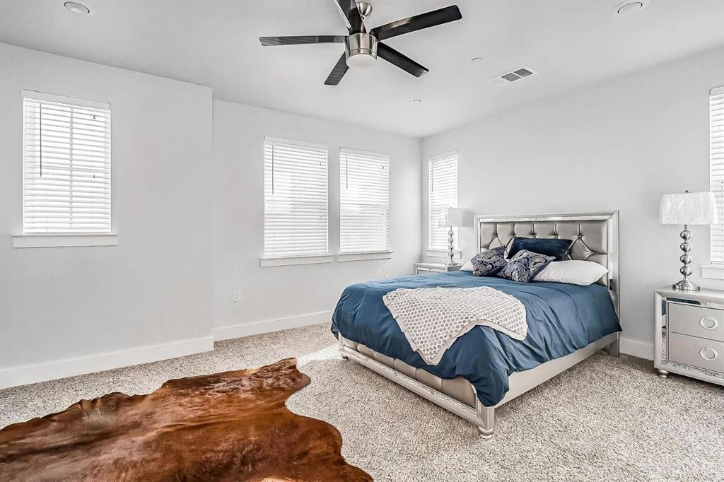 a bedroom with a bed lamp and window