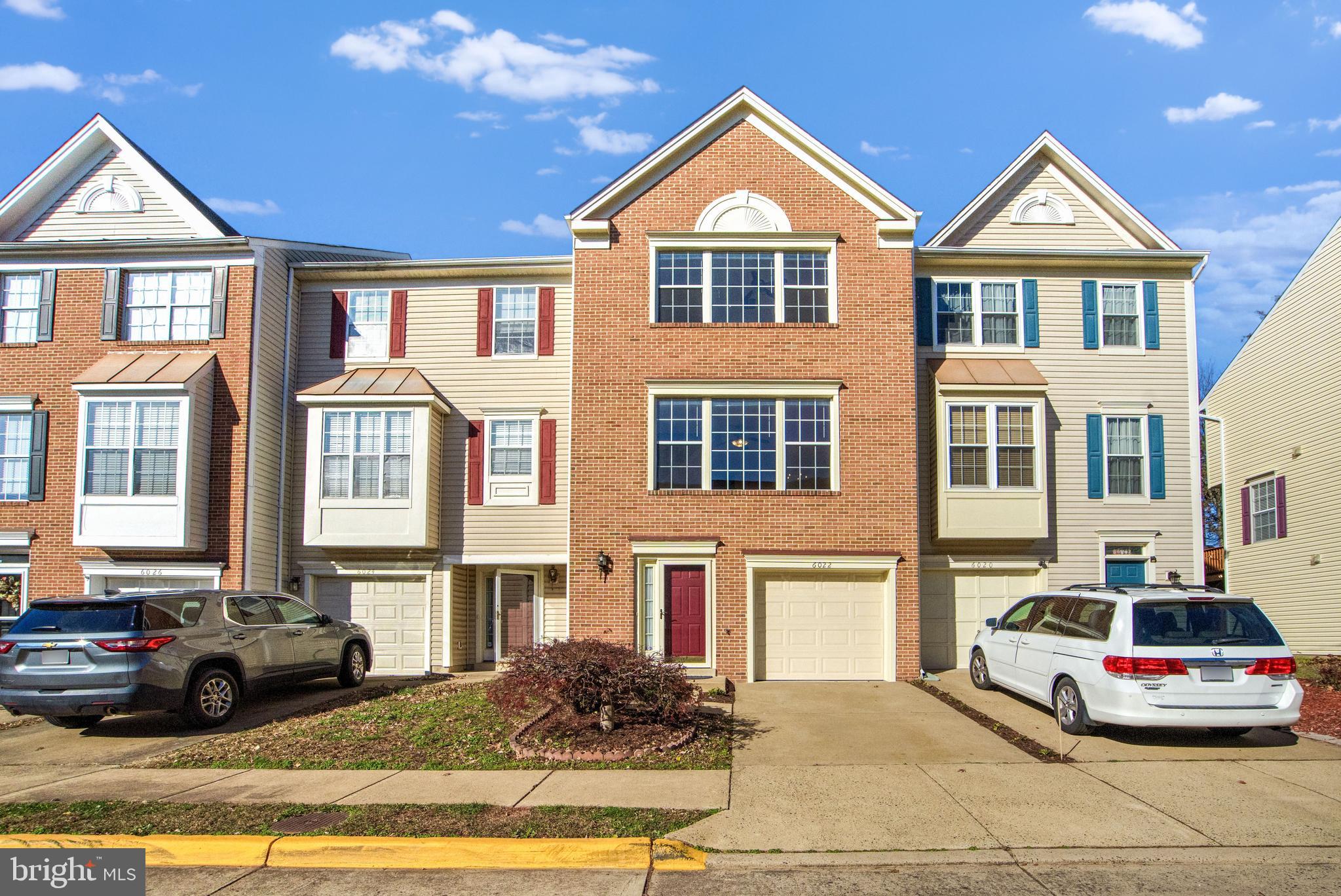 a front view of a residential apartment building with a yard