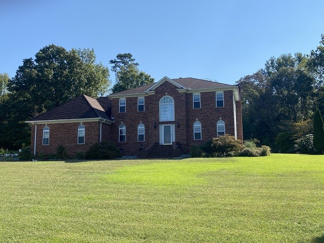 a front view of house with yard and green space