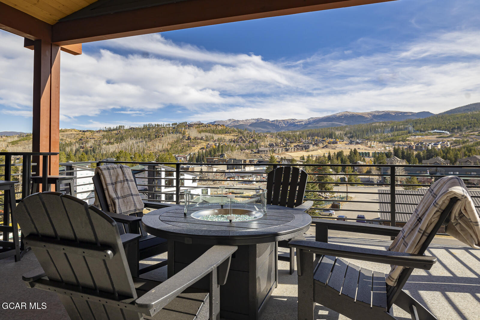 a view of a balcony with a table and chairs