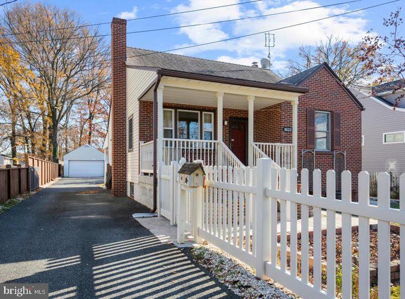 a view of a house with wooden fence