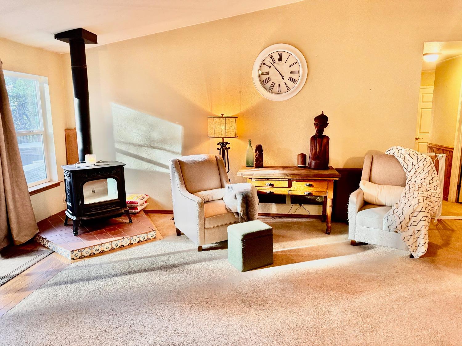 a living room with furniture a fireplace and a table