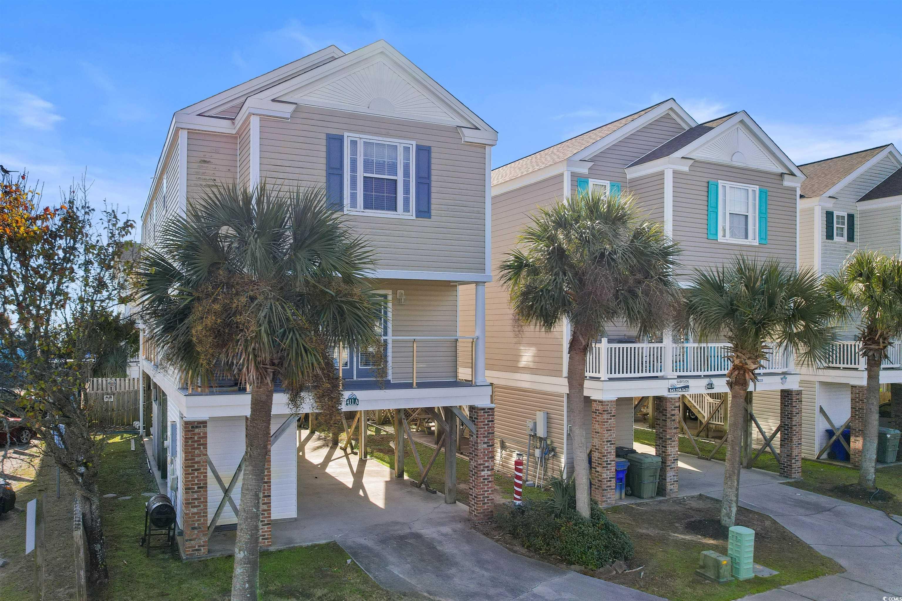 Coastal inspired home with a balcony and a carport