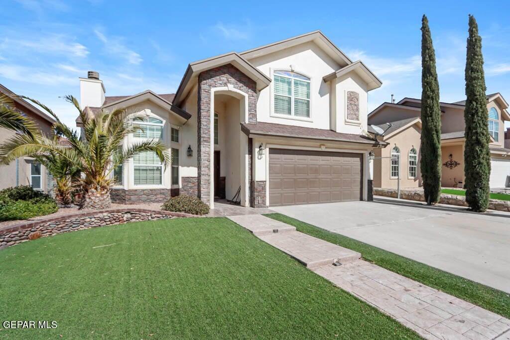 a front view of a house with a garden and yard