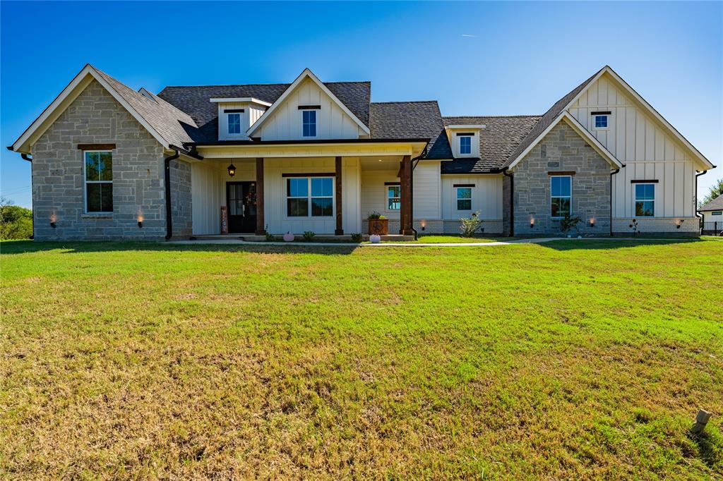 a front view of a house with swimming pool having outdoor seating