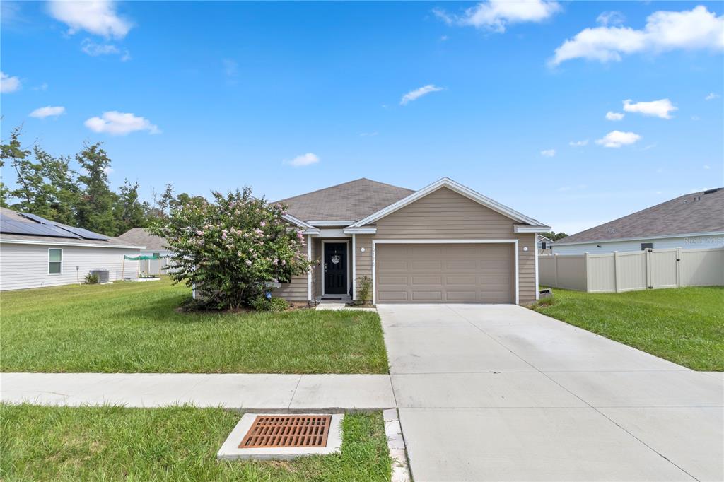 a front view of a house with a yard and garage