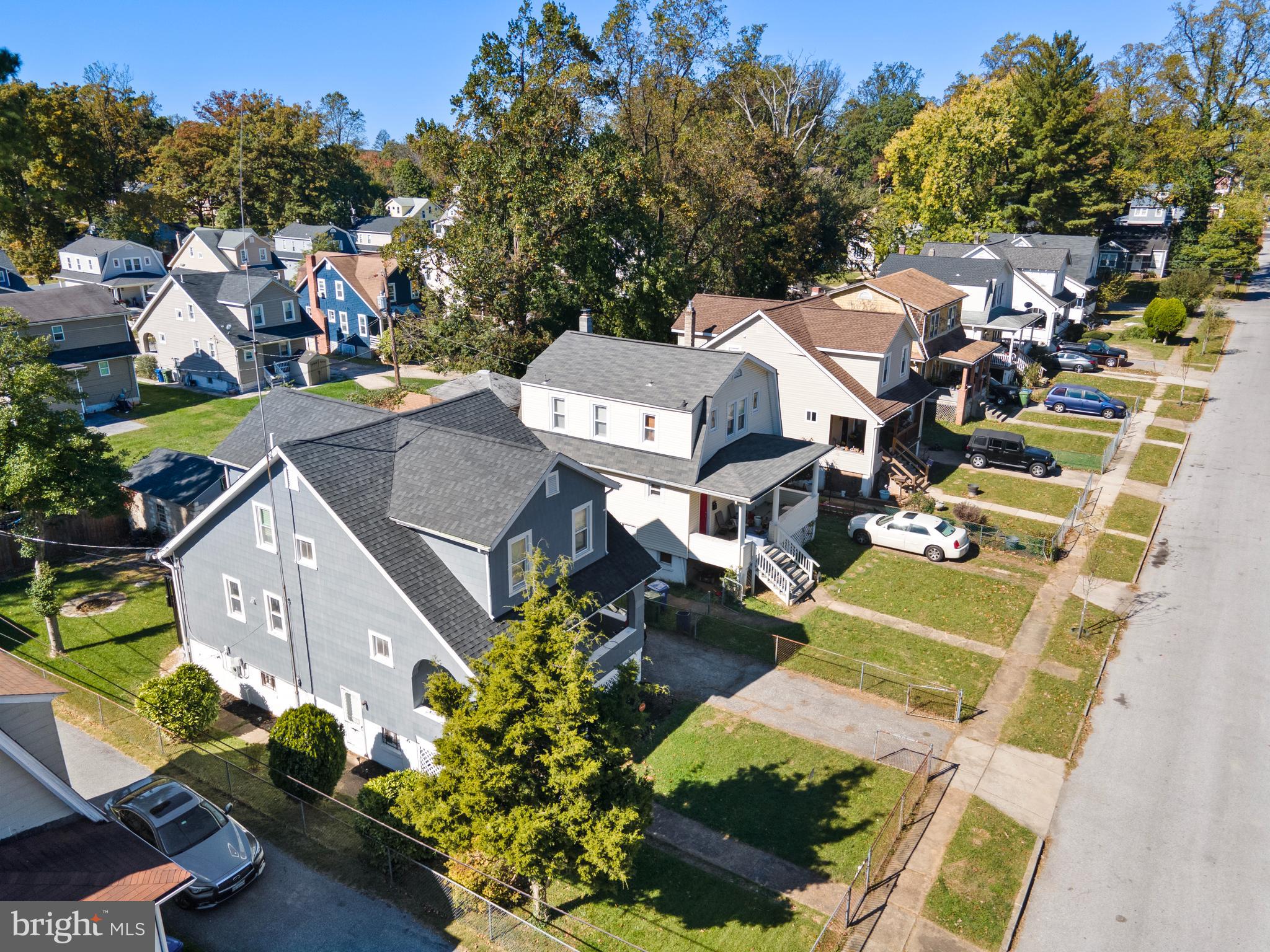 an aerial view of a house with a yard swimming pool and outdoor seating