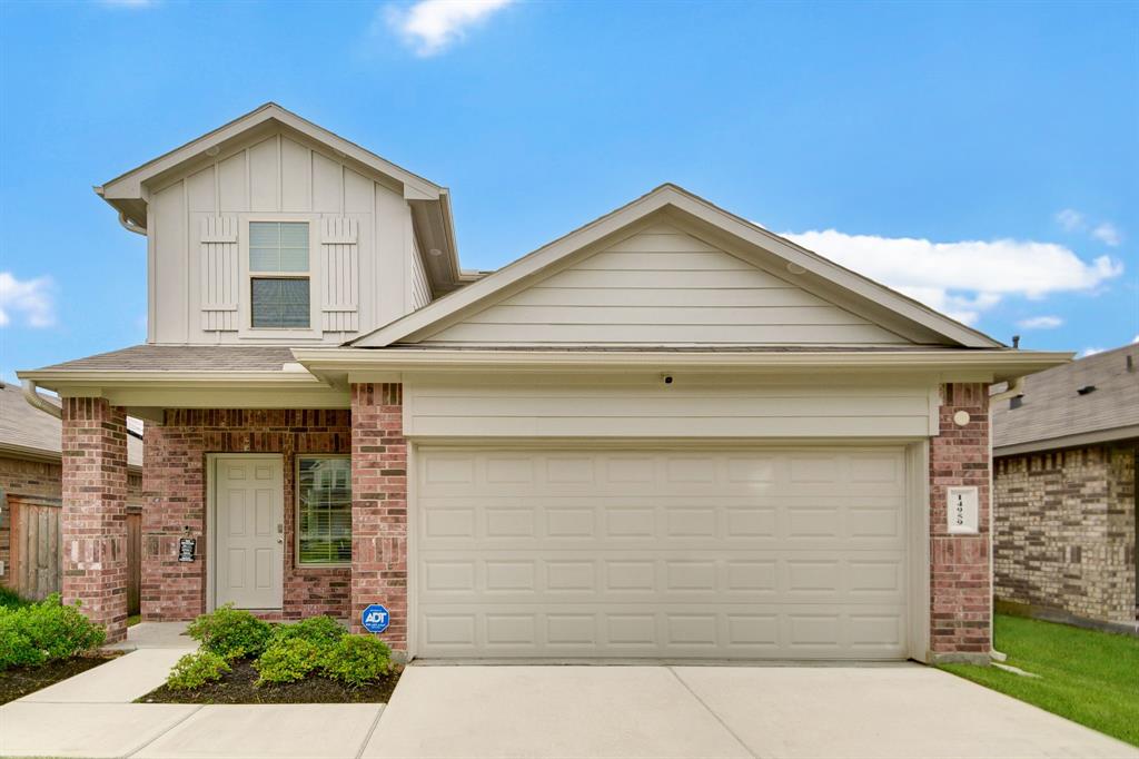 a front view of a house with garage