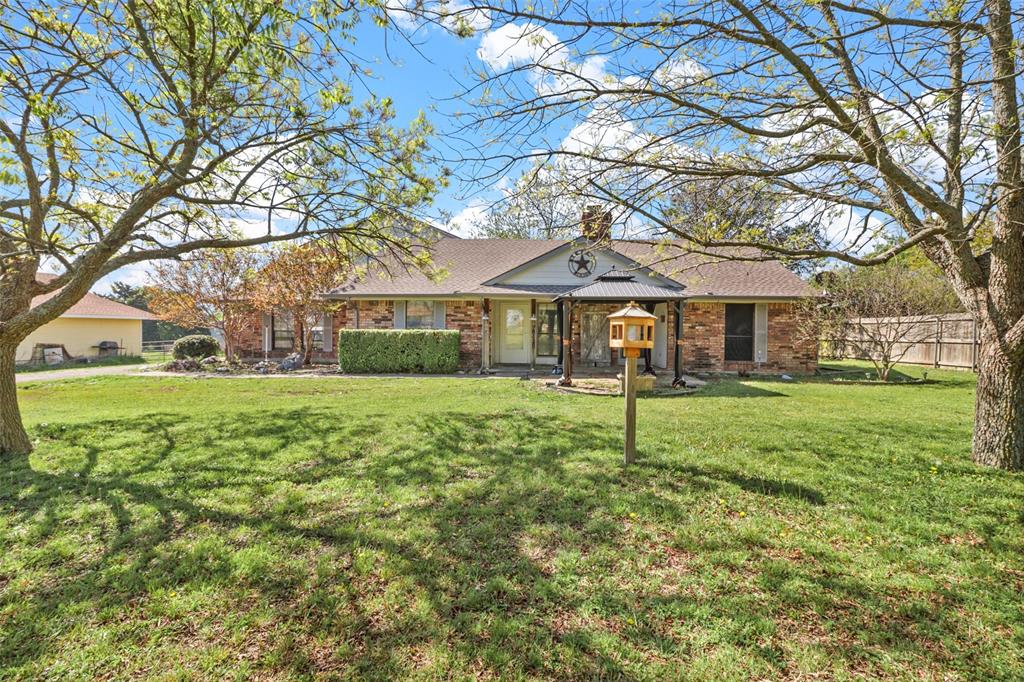 a house with green field in front of it