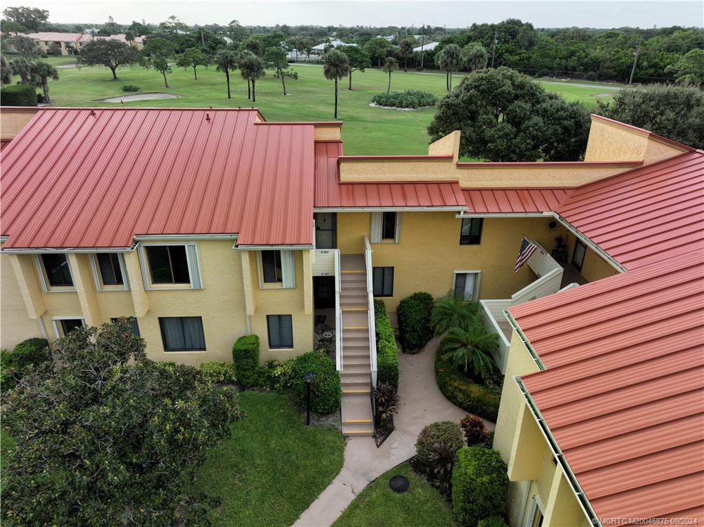 a aerial view of a house with pool and a garden