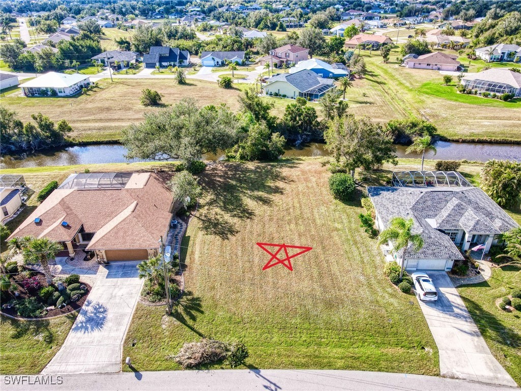 an aerial view of residential houses with outdoor space and swimming pool