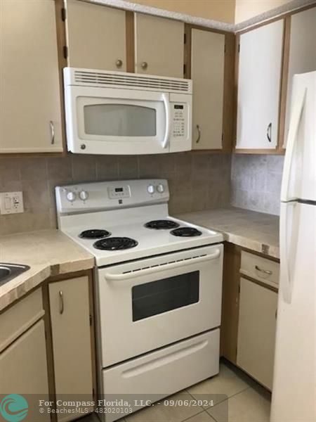 a kitchen with a stove and a microwave