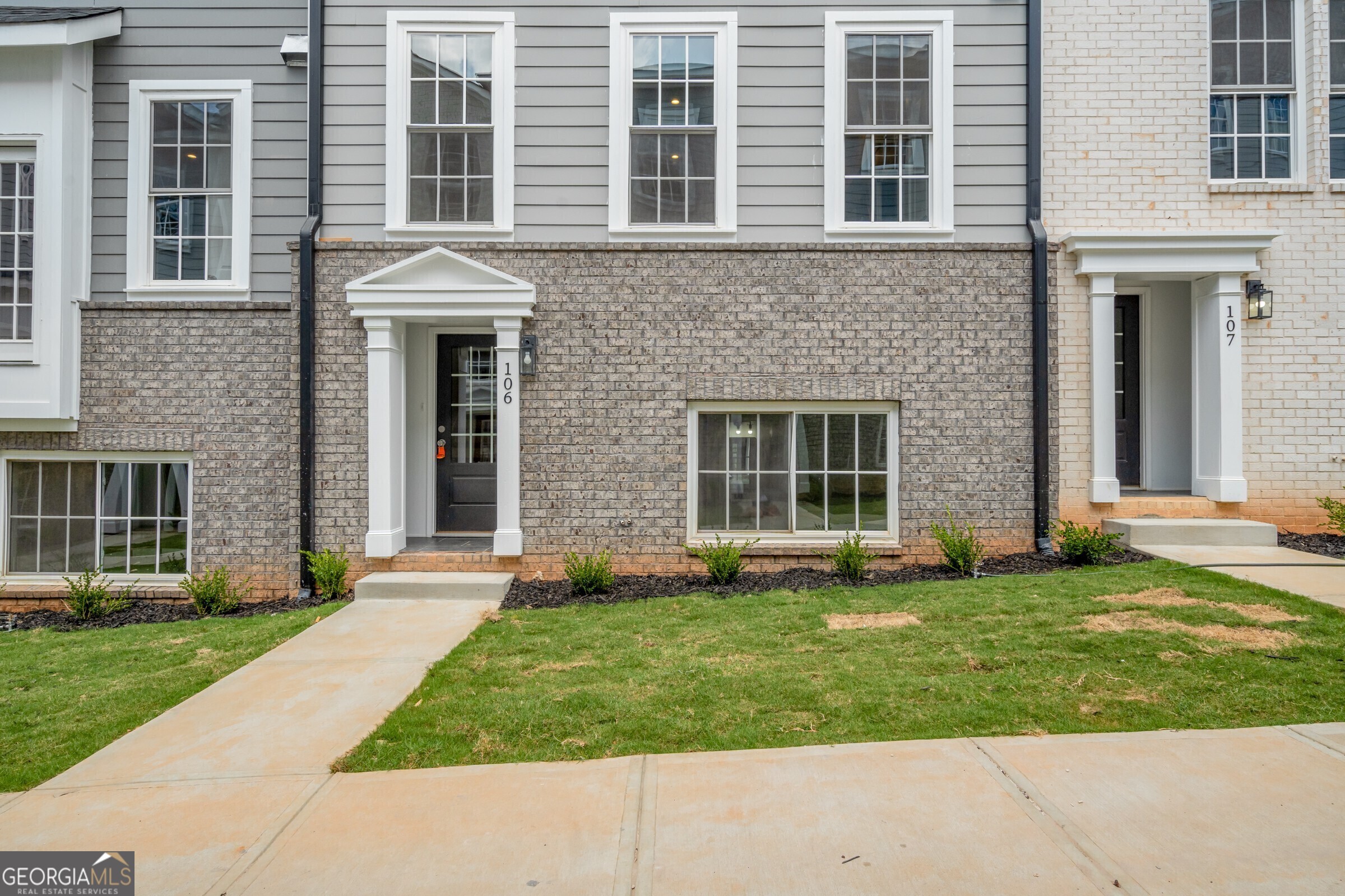 a front view of a house with a yard