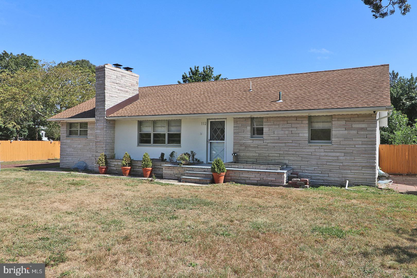 a front view of house with yard outdoor seating and barbeque oven