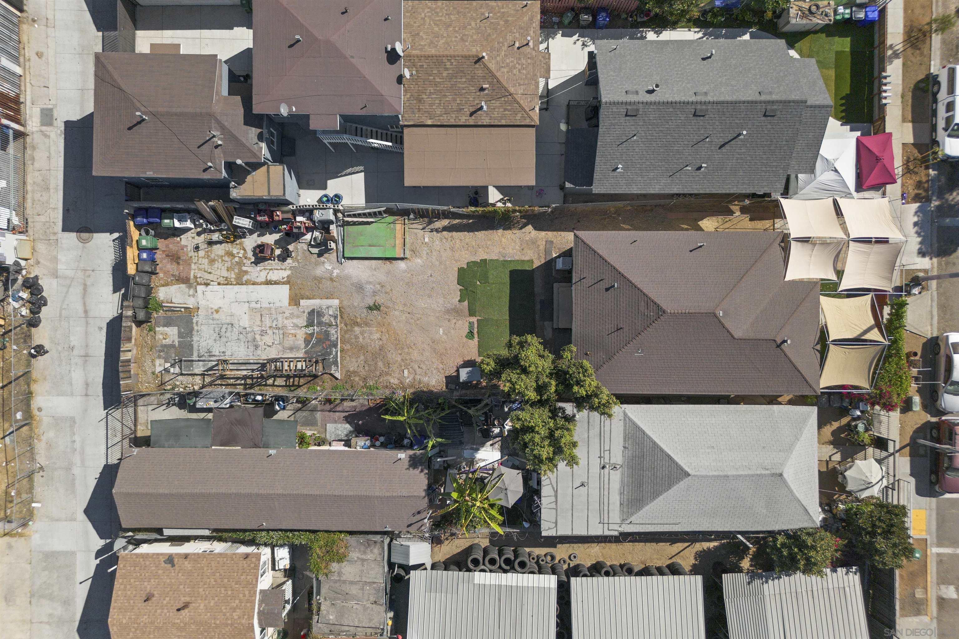 an aerial view of residential houses with outdoor space and parking