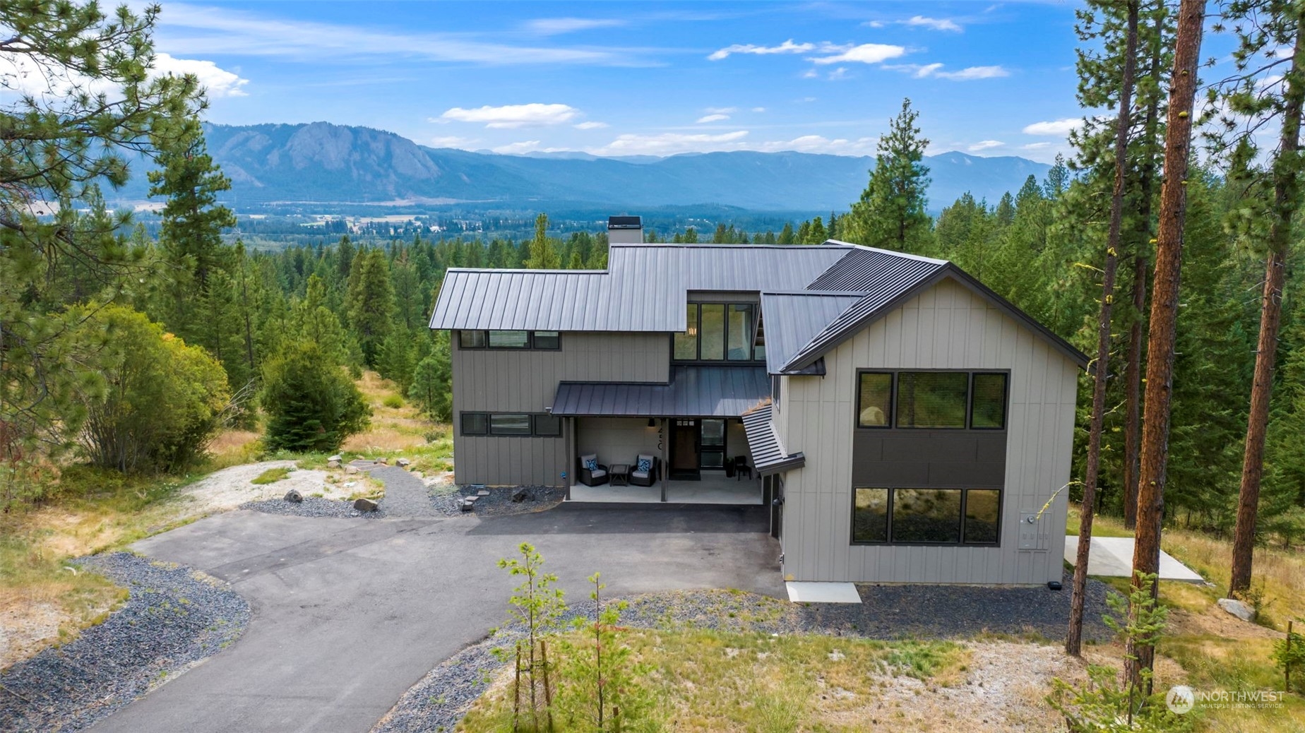 a view of a house with backyard and sitting area