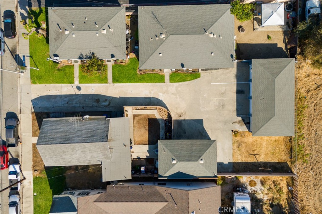 an aerial view of a house with a yard