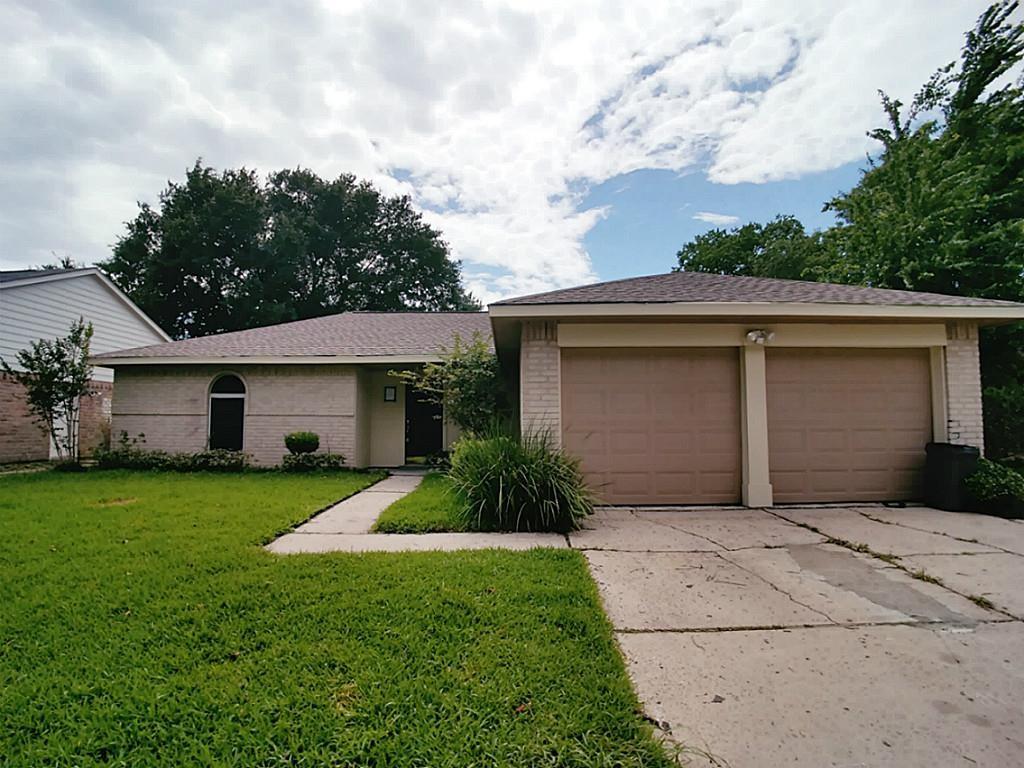 a front view of house with yard and trees