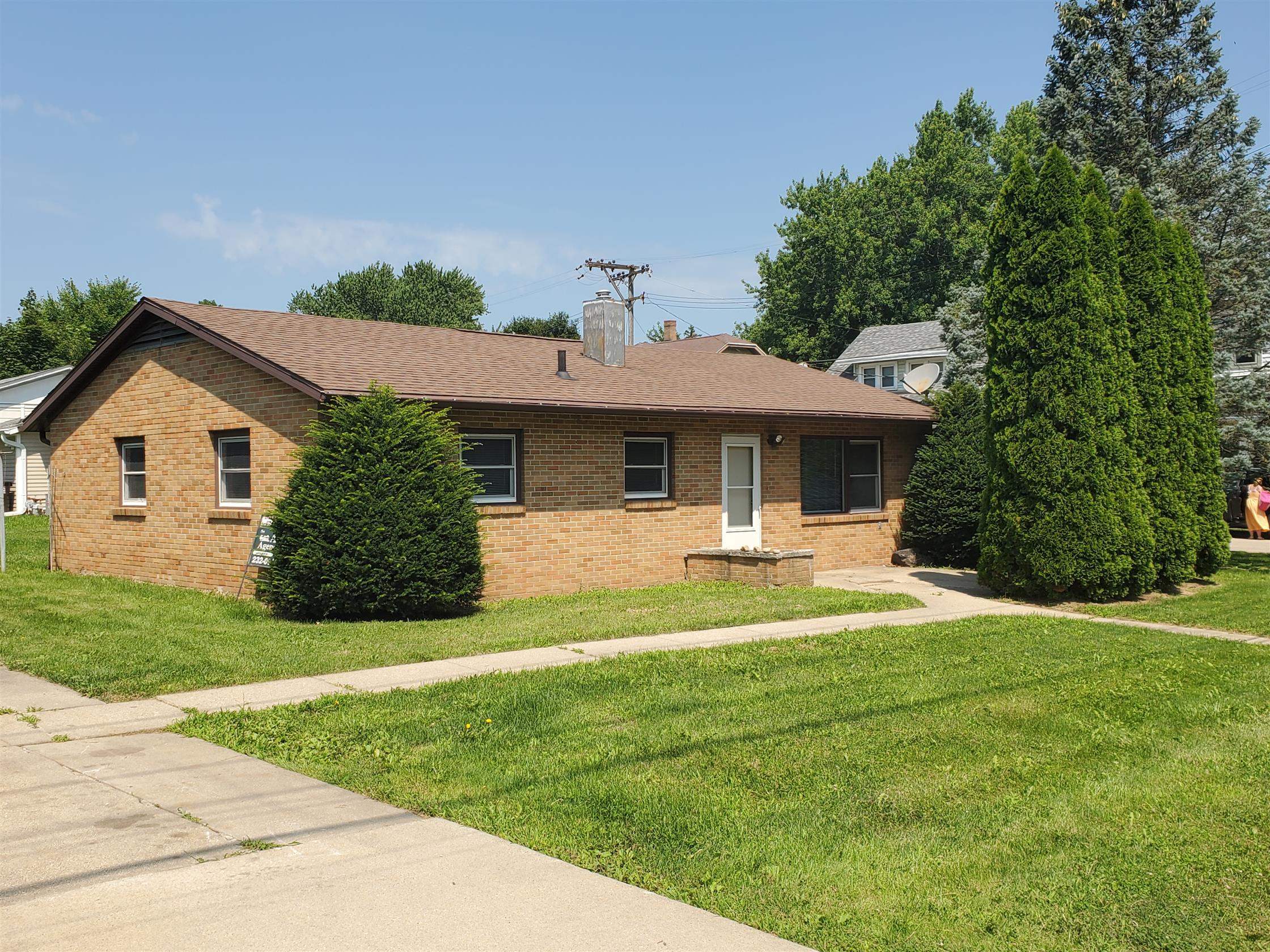 a front view of a house with a yard and porch