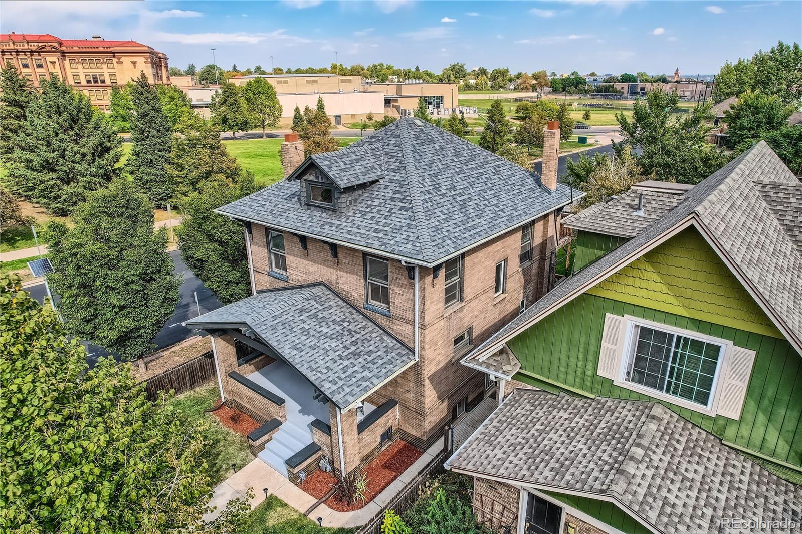 an aerial view of a house with a terrace patio and outdoor seating