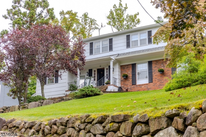 a view of a house with a yard and plants