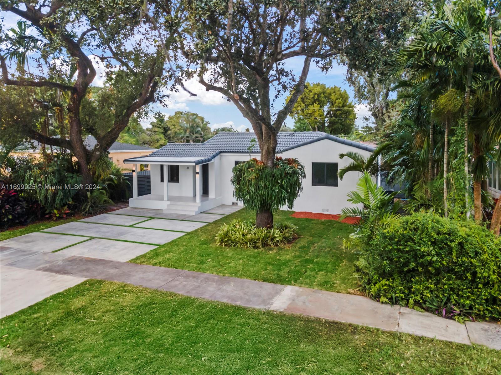 a front view of a house with a garden