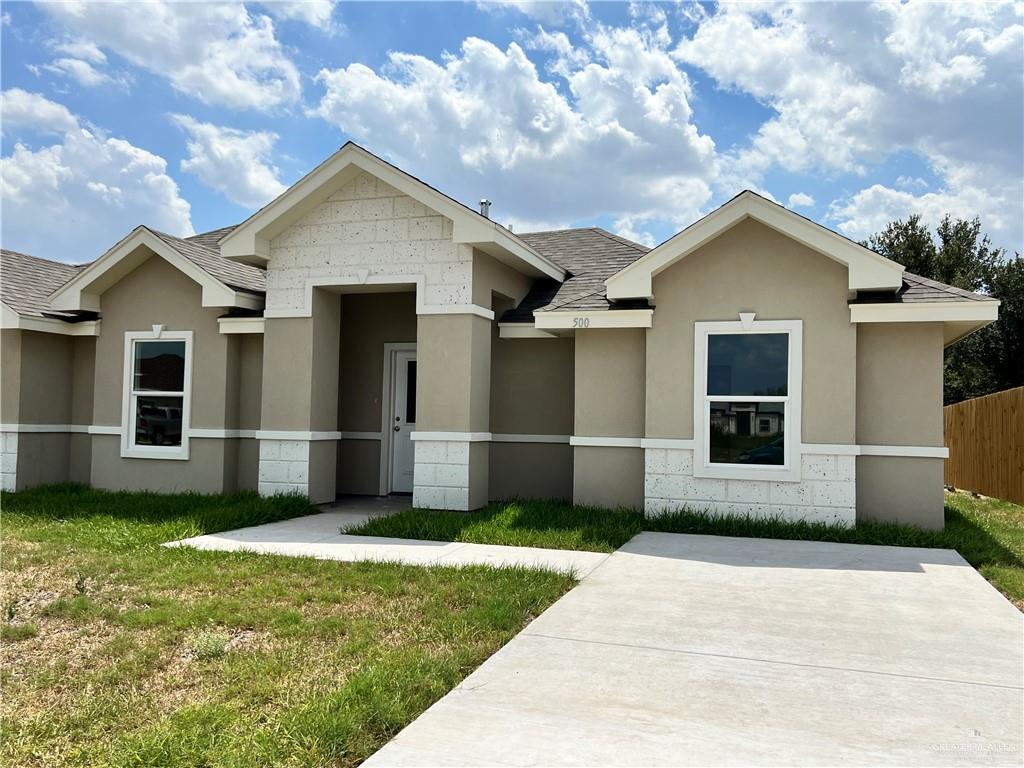 a front view of a house with garage