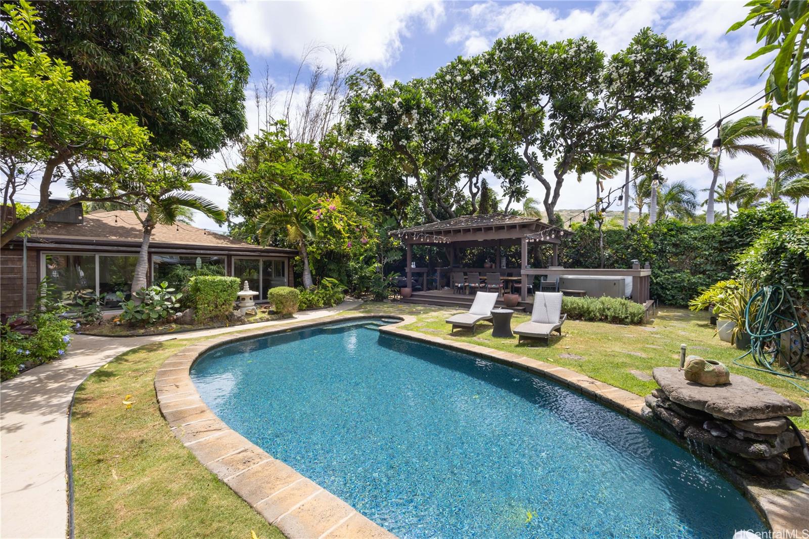 a view of a house with swimming pool and sitting area