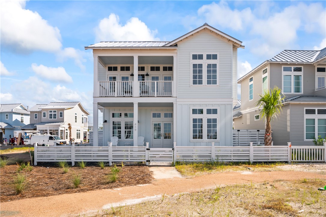 a front view of a house with swimming pool and porch