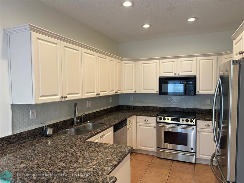 a kitchen with a stove and a sink