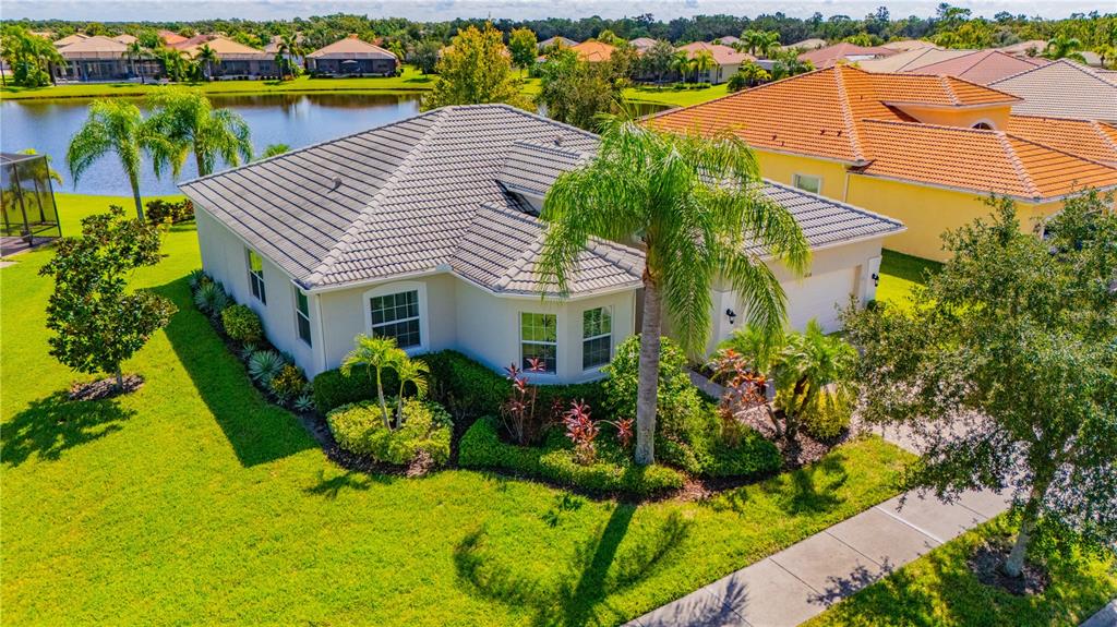 an aerial view of a house with swimming pool patio and outdoor seating