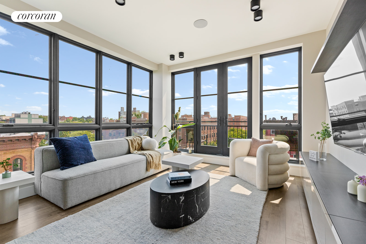 a living room with furniture and a floor to ceiling window