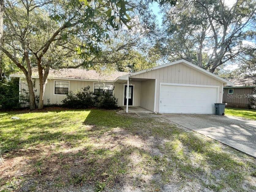 a view of a house with a yard and garage