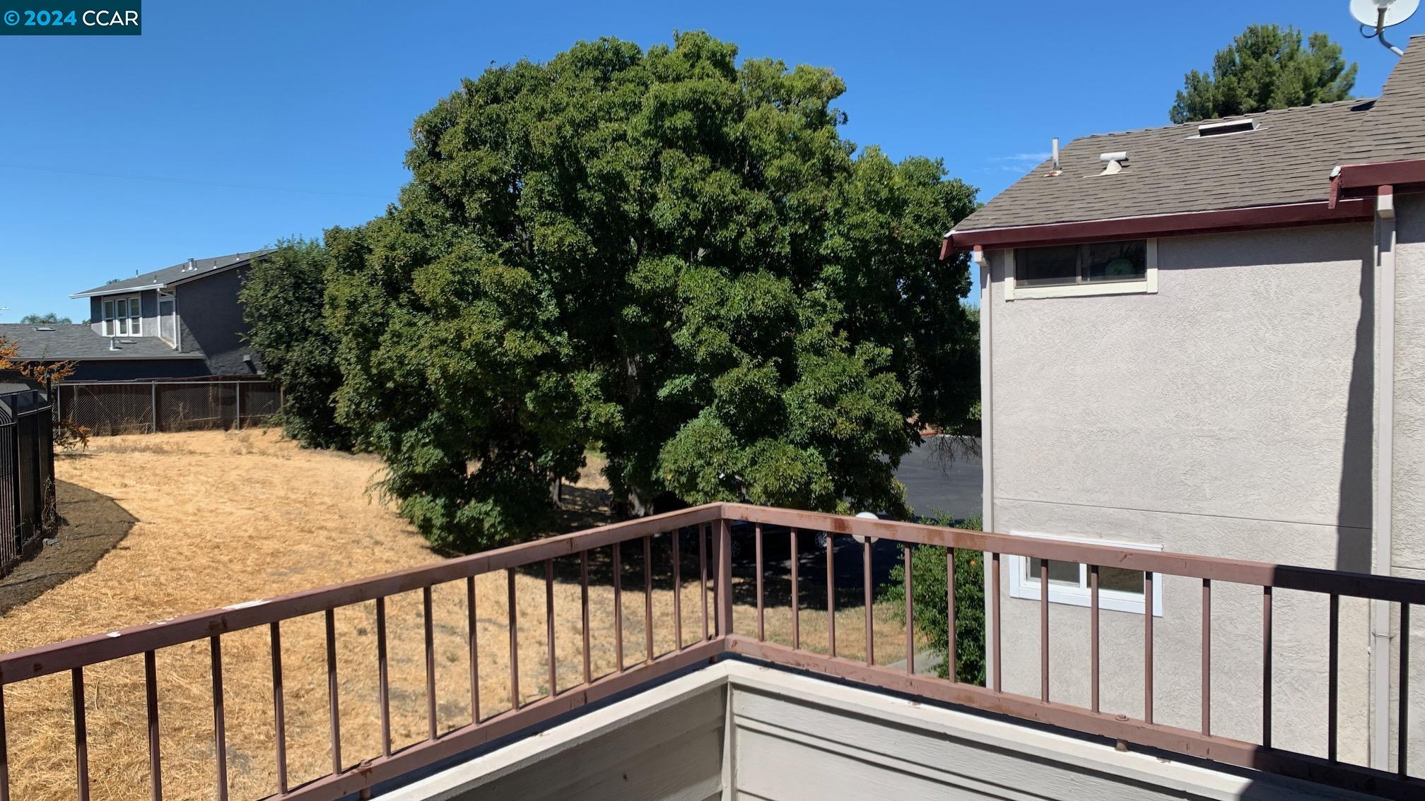 a view of balcony with wooden floor and fence