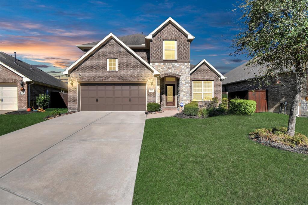 a front view of a house with a yard and garage