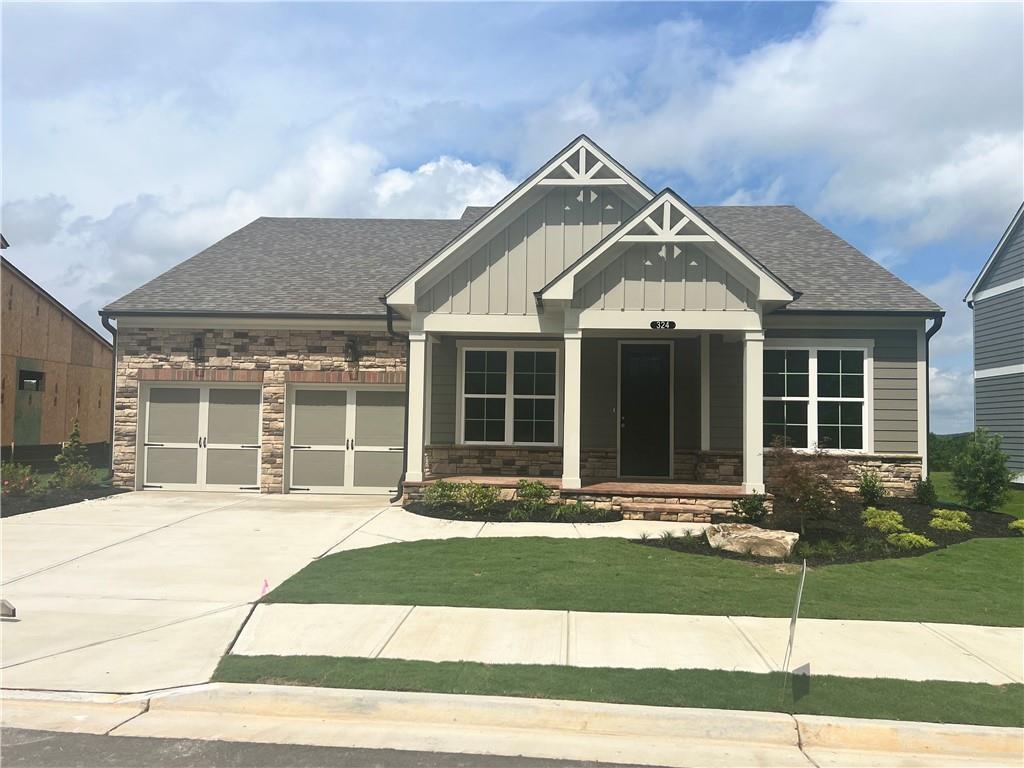 a front view of a house with a yard and outdoor seating