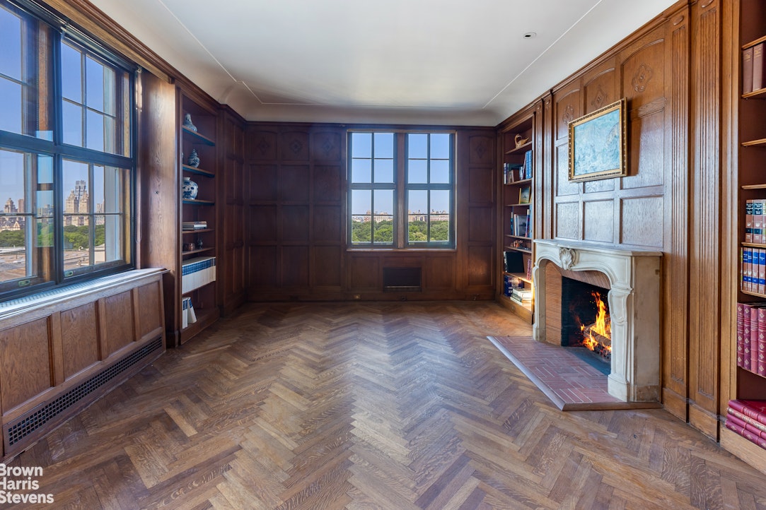 a view of an empty room with window and fire place