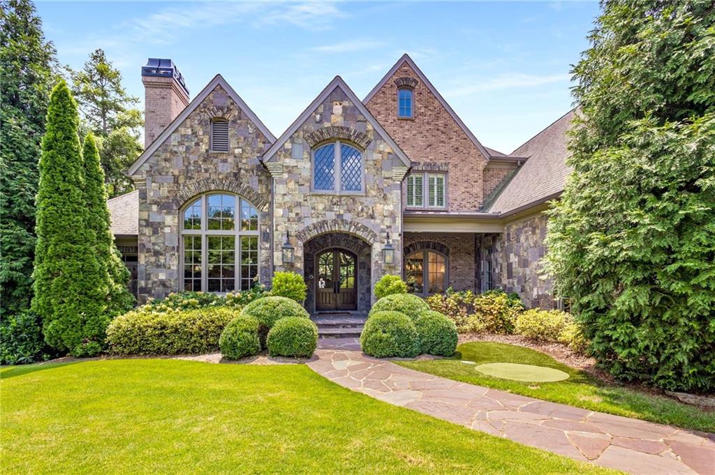 a front view of a house with a garden