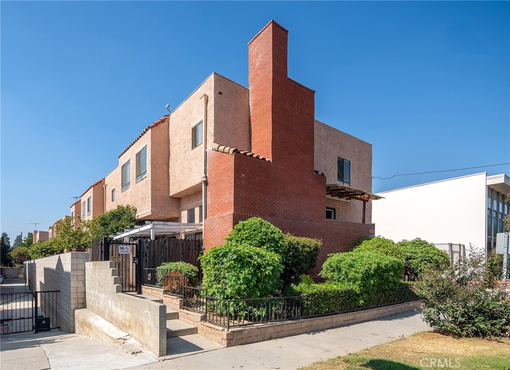 a front view of a building with plants