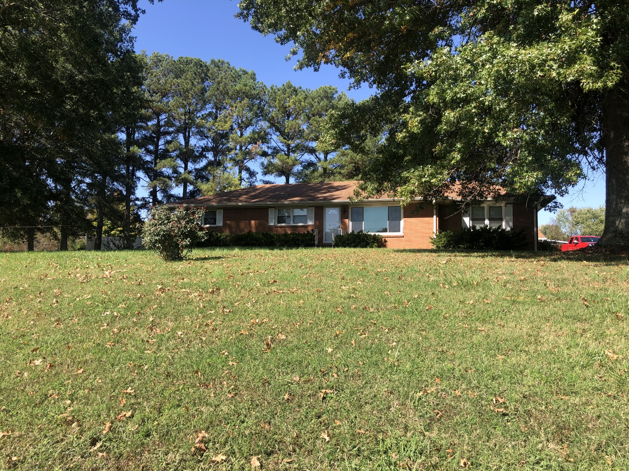 a view of a house with a yard and sitting area