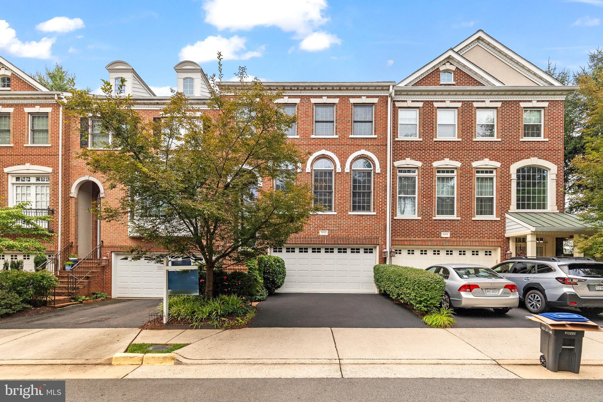 a front view of a residential apartment building with a yard