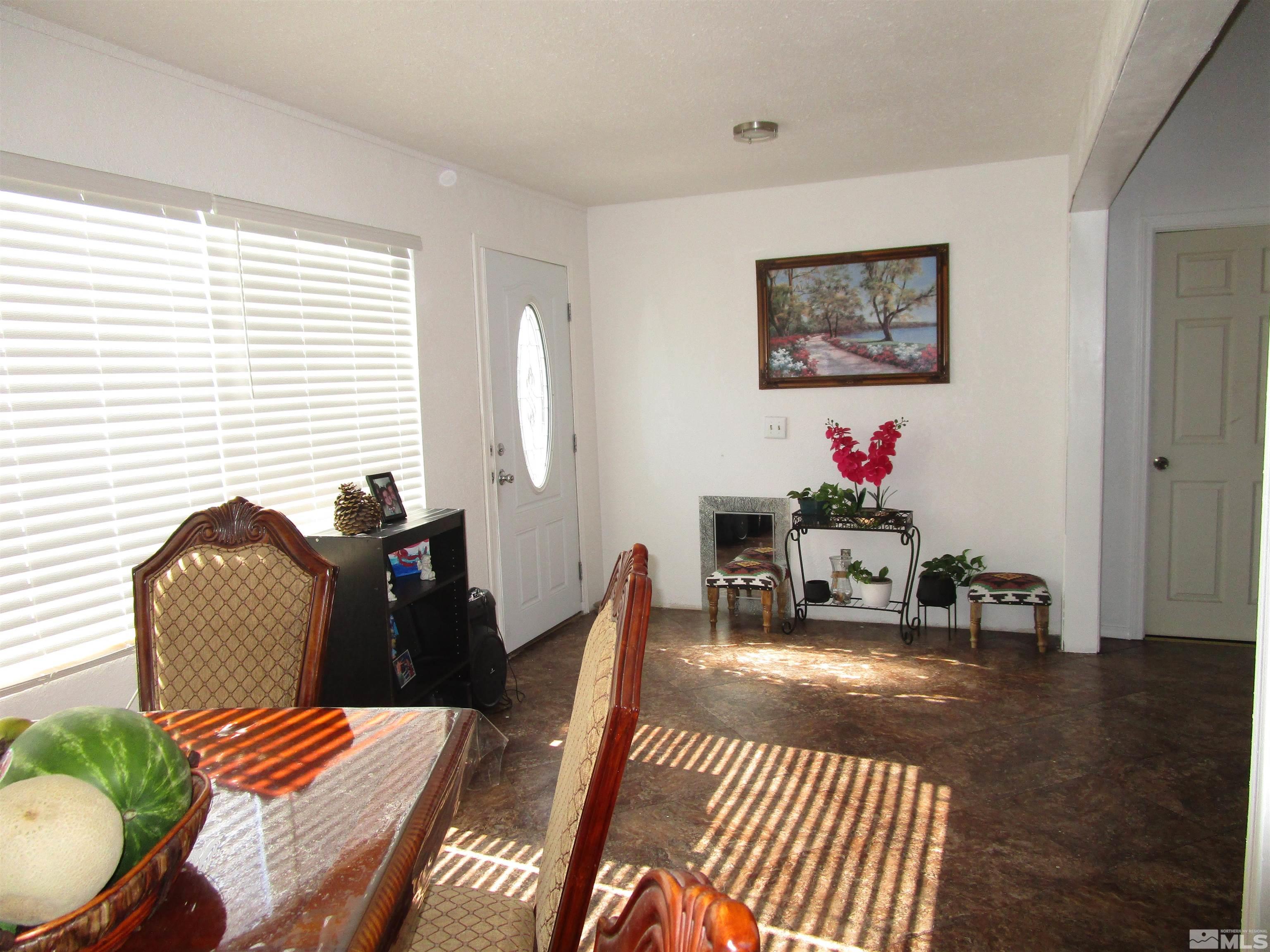 a living room with furniture a rug and a window