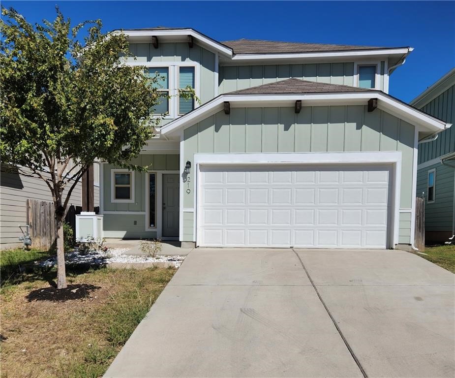 a front view of a house with garage