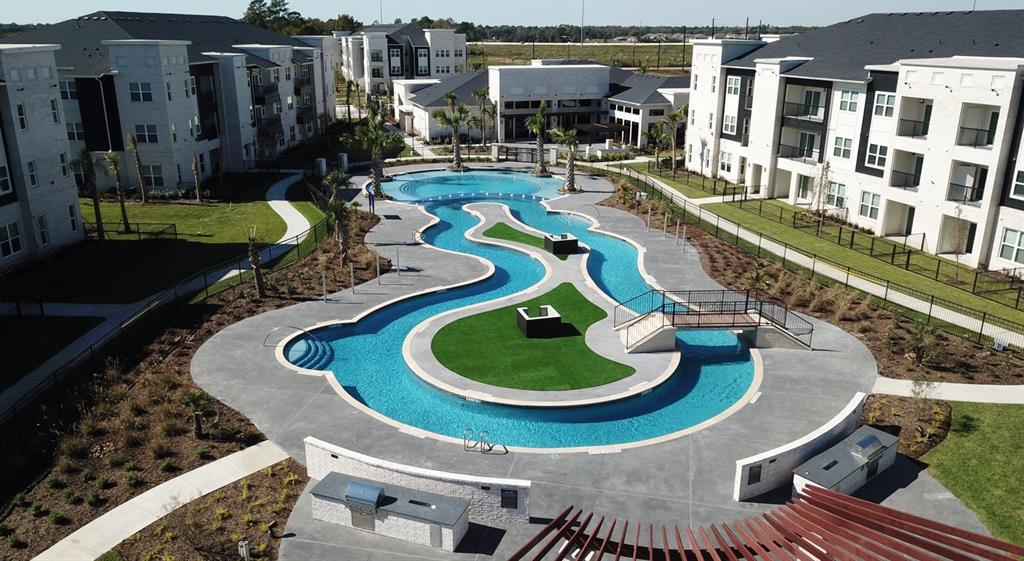 a swimming pool with outdoor seating and plants