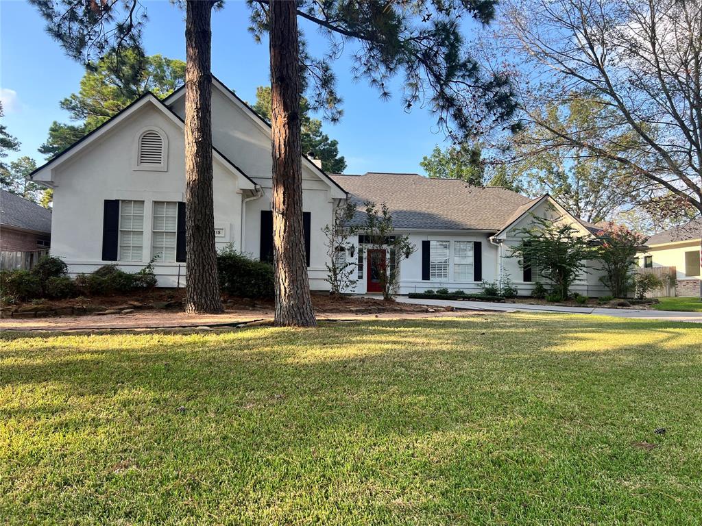 a view of a house with pool and a yard