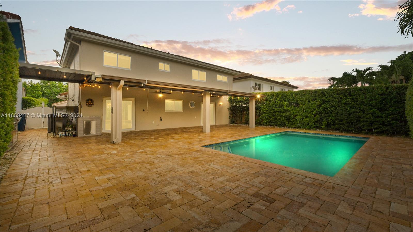 a backyard of a house with yard and outdoor seating