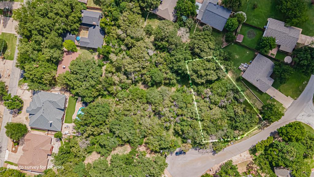 an aerial view of residential house with outdoor space and trees all around