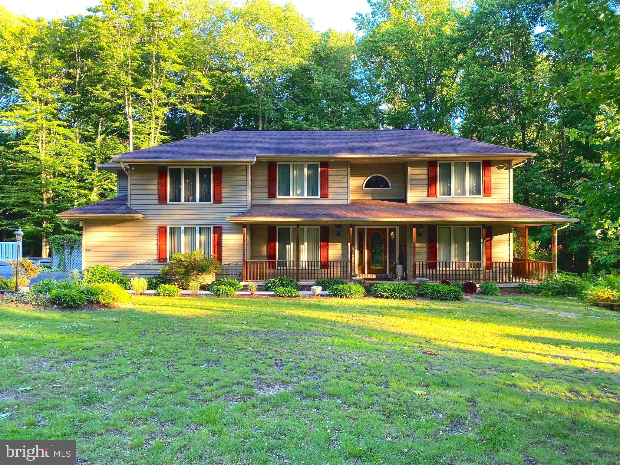 a front view of a house with swimming pool having outdoor seating