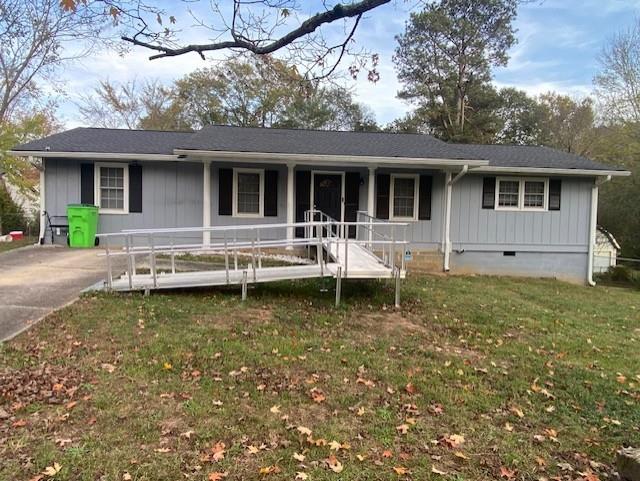 a backyard of a house with yard table and chairs