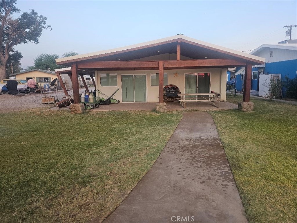 a front view of a house with swimming pool having outdoor seating